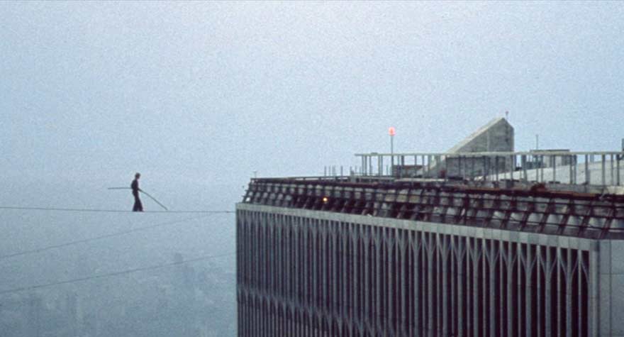 Philippe Petit walking a tightrope strung between the twin towers