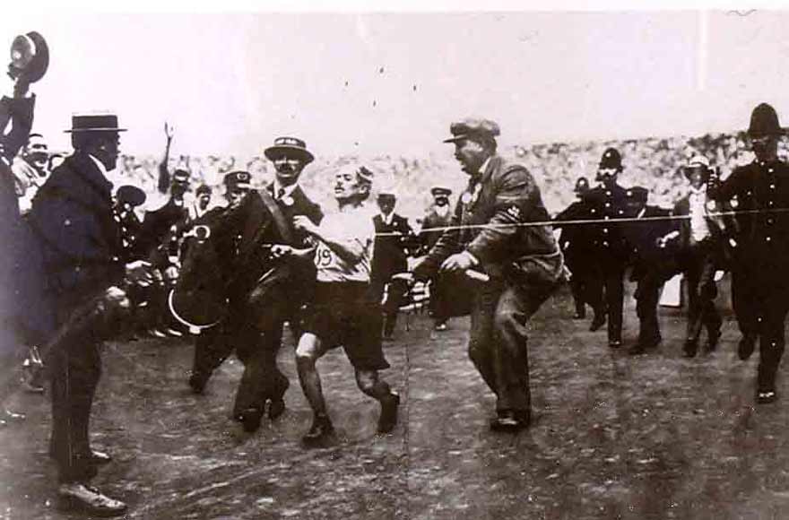 Dorando Pietri crosses the marathon finish line at the 1908 olympics